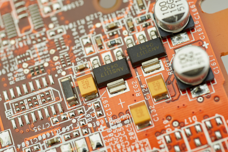 Close-up of an electronic circuit board with traces and chips